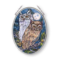 pair of owls with moon behind them